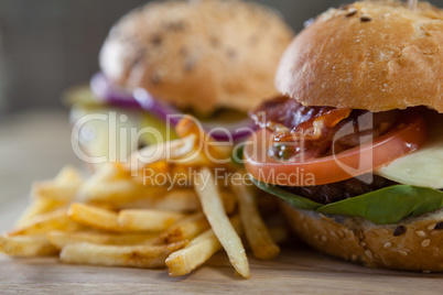 Hamburger and french fries on wooden table