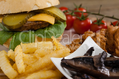 Hamburger and french fries on wooden table