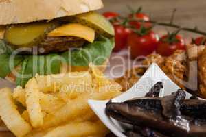 Hamburger and french fries on wooden table