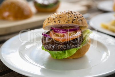 Close up of hamburger with vegetables in plate
