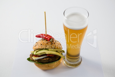 Hamburger with jalapeno by beer glass