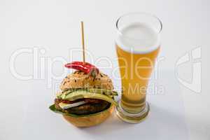 Hamburger with jalapeno by beer glass