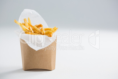 Close up of French fries in paper bag