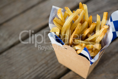 French fries with wax paper in container