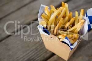 French fries with wax paper in container