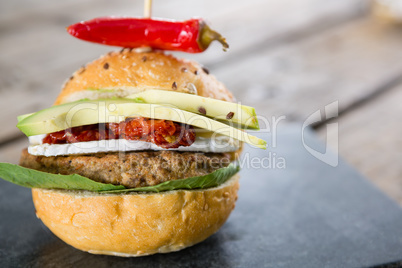 Close up burger with jalapeno pepper and vegetables