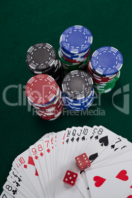 Playing cards, dices and casino chips on poker table