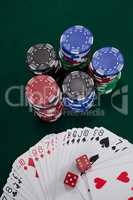 Playing cards, dices and casino chips on poker table