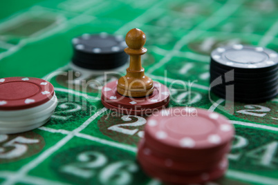 Close-up of coin and chips on roulette table