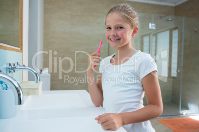 Portrait of girl holding toothbrush