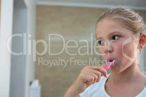 Close up of girl brushing teeth
