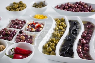 Marinated olives and vegetables on white background