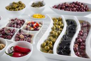 Marinated olives and vegetables on white background