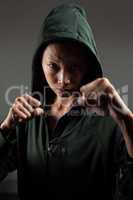 Determined woman practicing boxing in fitness studio