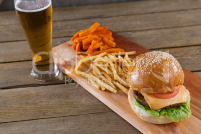 Burger and french fries with glass of beer