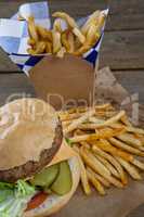 Close-up of hamburger and french fries in take way bag