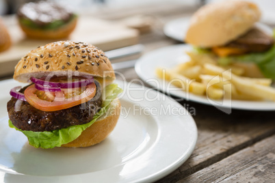 Close up of hamburger in plate on table