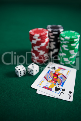 Playing cards, dices and casino chips on poker table