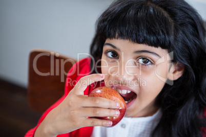 High angle portrait of girl eating fresh apple