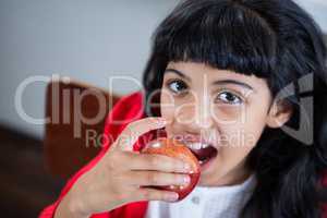 High angle portrait of girl eating fresh apple
