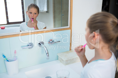 High angle view of girl brushing teeth