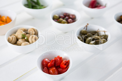 Marinated olives and vegetables on white background