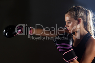 Woman practicing boxing in fitness studio