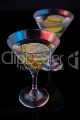 Cocktail martini with olives and lime on table