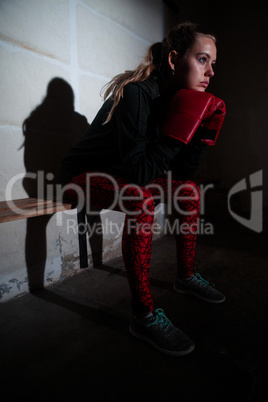 Thoughtful woman relaxing on bench