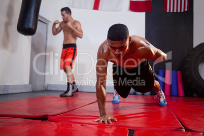 Men exercising in fitness studio