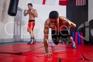 Men exercising in fitness studio
