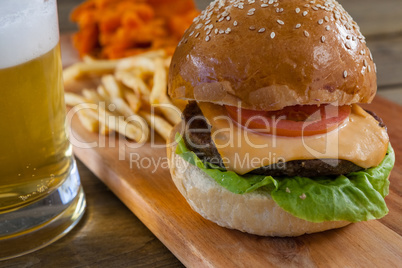 Burger and french fries with glass of beer