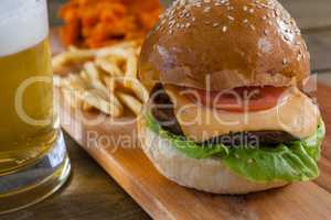 Burger and french fries with glass of beer