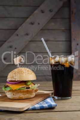 Hamburger and cold drink on table