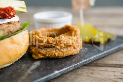 Onion rings by burger on slate