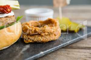 Onion rings by burger on slate