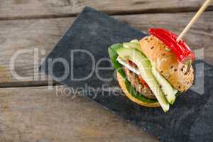 Overhead view of Burger with jalapeno pepper on slate