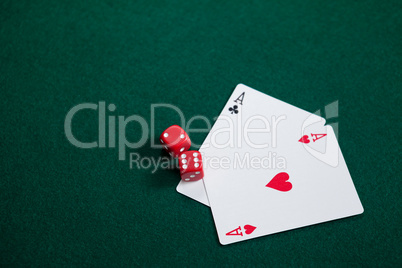 Pair of dice and playing cards on poker table