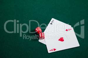 Pair of dice and playing cards on poker table
