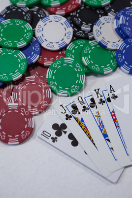 Playing cards and casino chips on white background