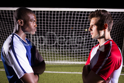 Side view of young male soccer players looking at each other