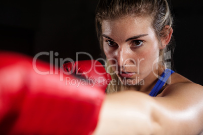 Woman practicing boxing in fitness studio