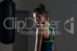 Determined woman standing in fitness studio