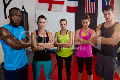 Portrait of multi-ethnic athletes standing with arms crossed