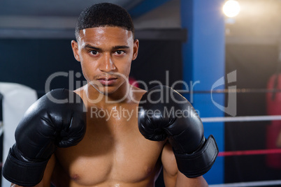 Portrait of male boxer wearing black gloves