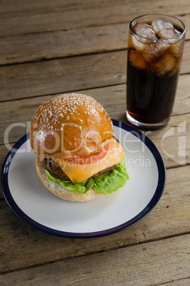 Hamburger in plate with glass of cold drink