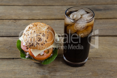 Hamburger and cold drink on table