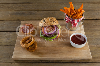 Hamburger, french fries, onion ring and tomato sauce