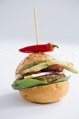 Close up of burger with jalapeno pepper