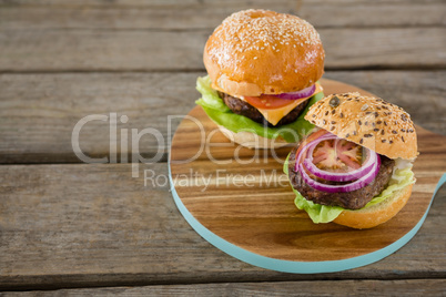 High angle view of burgers on cutting board